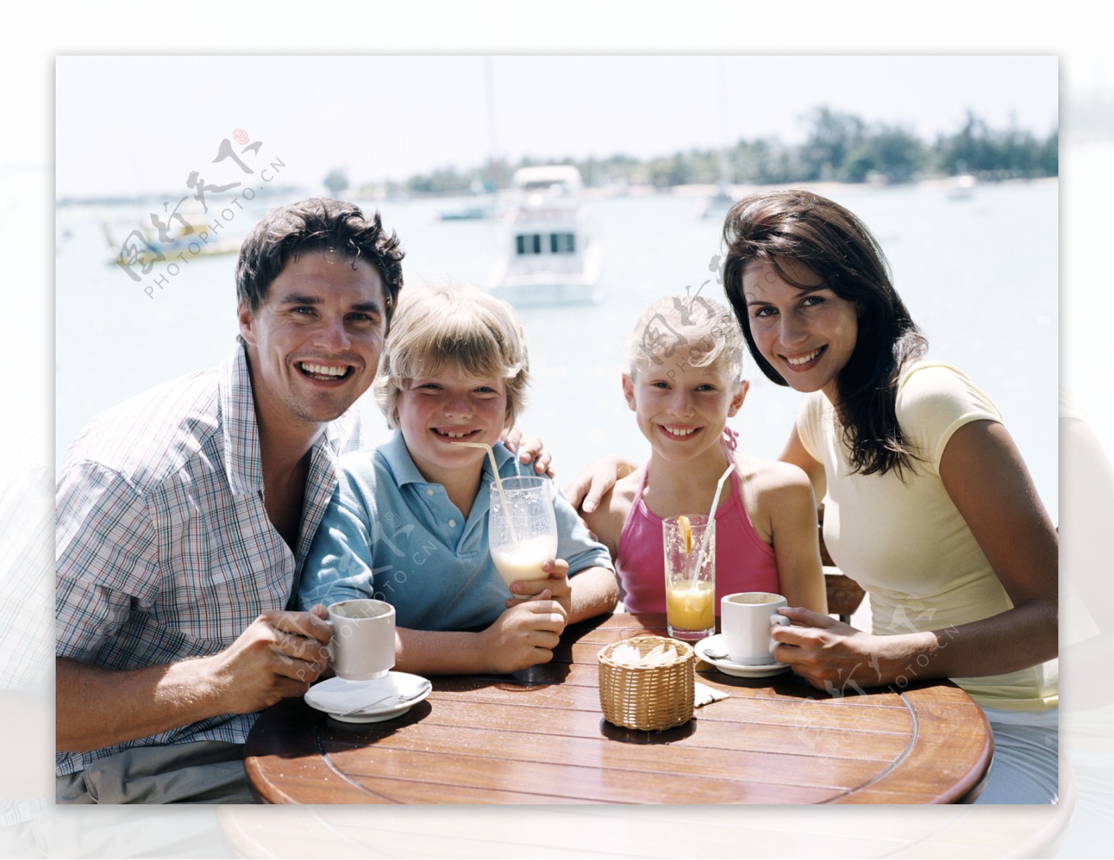 海边喝果汁的一家人图片