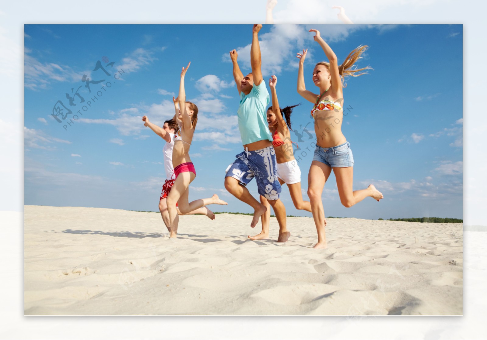 沙滩上跳跃的青年男女图片