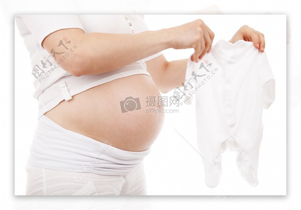 怀孕的女性拿着婴儿服装